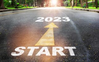 Start to 2023 written on the road with an arrow pointing from Start to 2023 with a sunny nature background